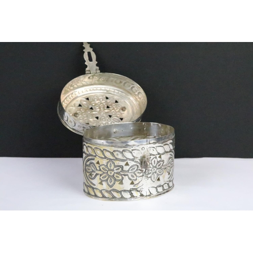 306 - Silverplated Chinese cricket box of oval form with moulded florals and pierced sides and lid with hi... 