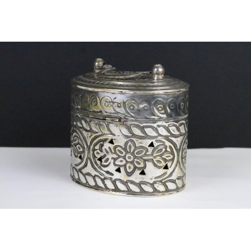 306 - Silverplated Chinese cricket box of oval form with moulded florals and pierced sides and lid with hi... 