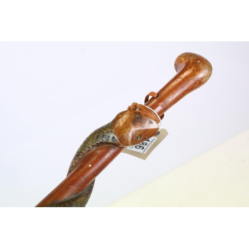 186 - Wooden walking stick with carved snake detailing modelled wrapped around the shaft, together with an... 