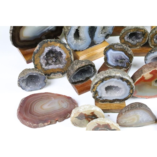 325 - Collection of geode mineral specimens, each sliced and mounted on wooden bases, including amethyst s... 