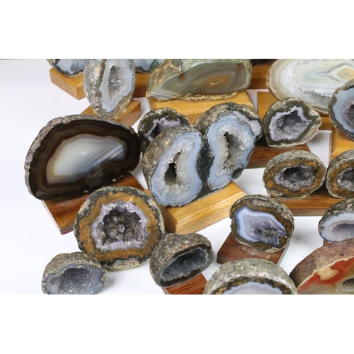 325 - Collection of geode mineral specimens, each sliced and mounted on wooden bases, including amethyst s... 