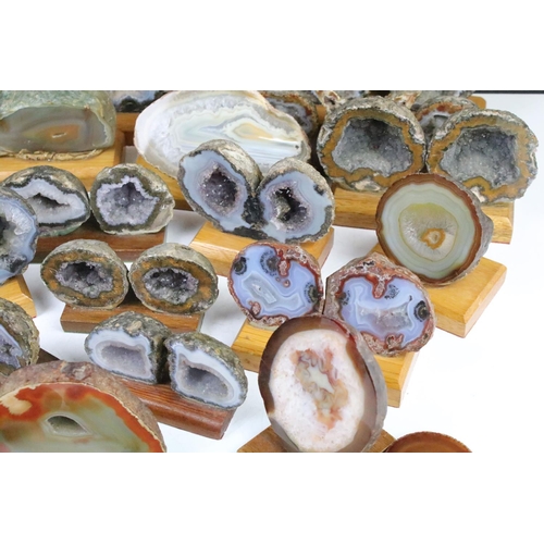 325 - Collection of geode mineral specimens, each sliced and mounted on wooden bases, including amethyst s... 