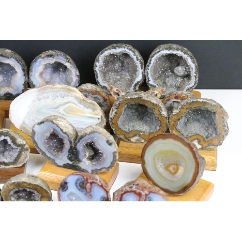 325 - Collection of geode mineral specimens, each sliced and mounted on wooden bases, including amethyst s... 