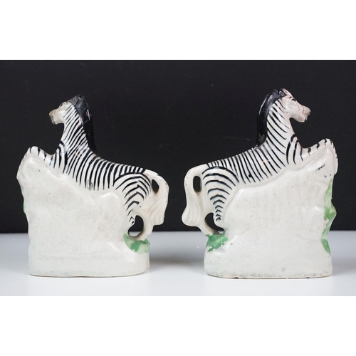 14 - Pair of 19th Century Staffordshire pottery zebras, approx 16.5cm tall