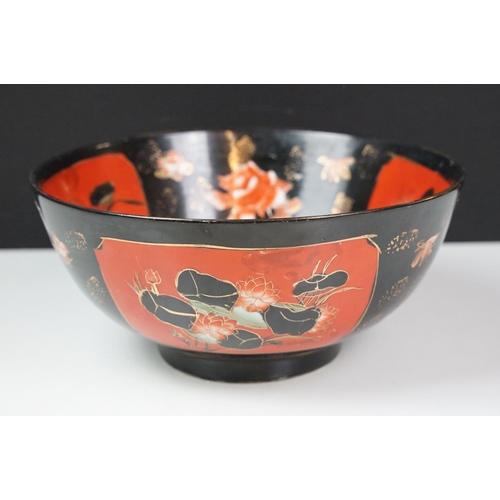 16 - Set of four Japanese black ground ceramic bowls decorated with red ground floral panels with gilt bo... 