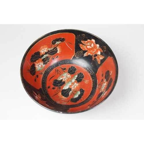 16 - Set of four Japanese black ground ceramic bowls decorated with red ground floral panels with gilt bo... 