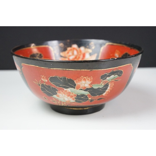 16 - Set of four Japanese black ground ceramic bowls decorated with red ground floral panels with gilt bo... 