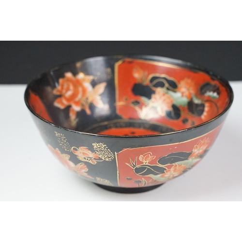 16 - Set of four Japanese black ground ceramic bowls decorated with red ground floral panels with gilt bo... 