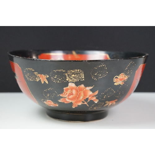 16 - Set of four Japanese black ground ceramic bowls decorated with red ground floral panels with gilt bo... 