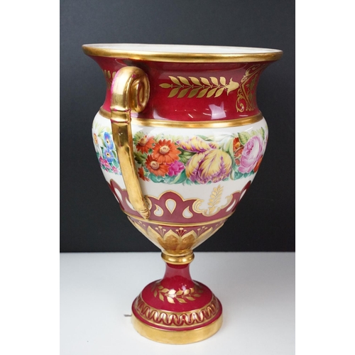 20 - 19th Century continental twin handled urn vase with floral decoration on a pink ground, with gilt de... 