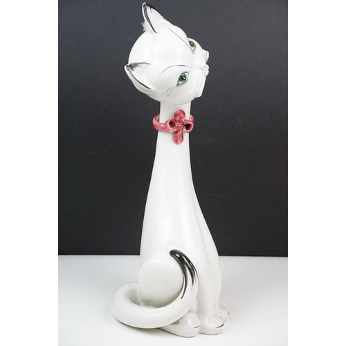 21 - Retro Italian pottery cat, white and black wearing a pink ribbon to neck, marked Italy to base, 45cm... 