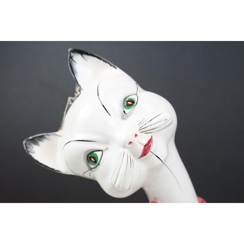 21 - Retro Italian pottery cat, white and black wearing a pink ribbon to neck, marked Italy to base, 45cm... 