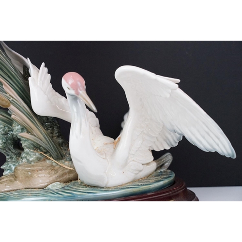 22 - Lladro Cranes porcelain figure group, no. 1456, one bird with outstretched wings on the water, anoth... 