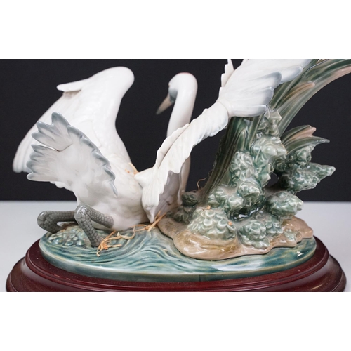 22 - Lladro Cranes porcelain figure group, no. 1456, one bird with outstretched wings on the water, anoth... 