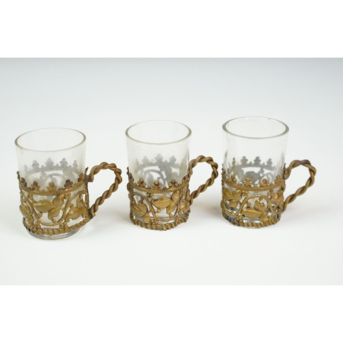 26 - Late 19th / early 20th century communion set of 12 glasses with brass holders, with circular tray, p... 