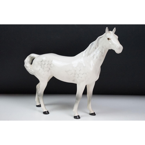 27 - Beswick - A porcelain figure of a Lipizzaner horse and rider, marked to base and numbered 53, approx... 