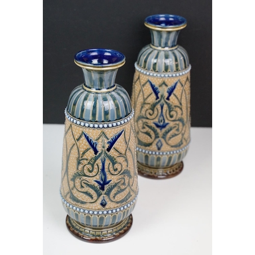 40 - Near pair of late 19th century Doulton Lambeth stoneware vases with incised foliate decoration, inci... 