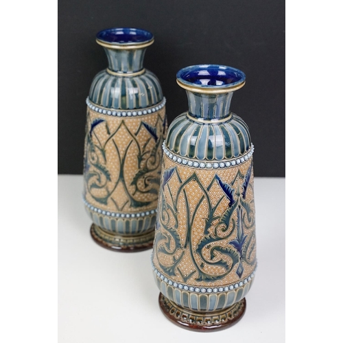 40 - Near pair of late 19th century Doulton Lambeth stoneware vases with incised foliate decoration, inci... 