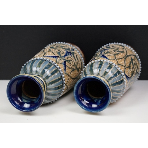 40 - Near pair of late 19th century Doulton Lambeth stoneware vases with incised foliate decoration, inci... 