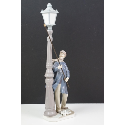 56 - Lladro ceramic figurine in the form of a Victorian lamp lighter complete in original box. Measures 4... 