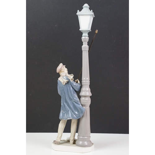 56 - Lladro ceramic figurine in the form of a Victorian lamp lighter complete in original box. Measures 4... 