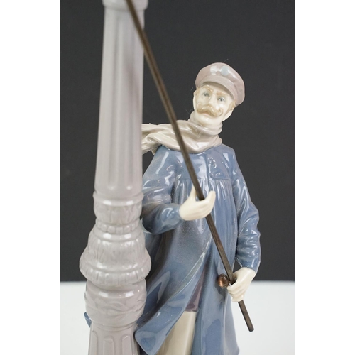 56 - Lladro ceramic figurine in the form of a Victorian lamp lighter complete in original box. Measures 4... 