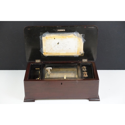 148 - 19th Century Swiss music box, the lid opening to a brass cylinder (approx 12cm long) and one piece c... 