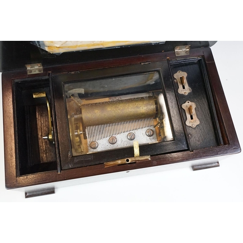 148 - 19th Century Swiss music box, the lid opening to a brass cylinder (approx 12cm long) and one piece c... 