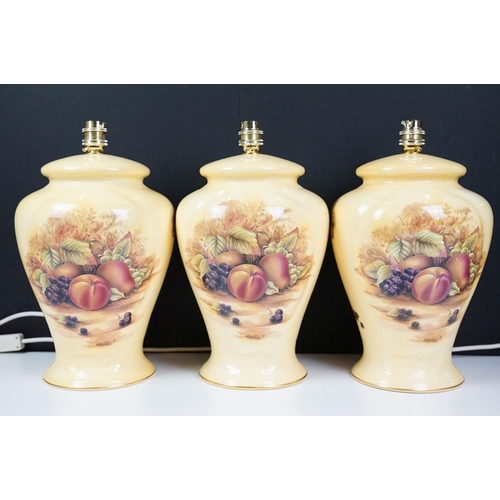 72 - Collection of table lamps to include three Aynsley fruit decorated lamp bases together with a pair o... 