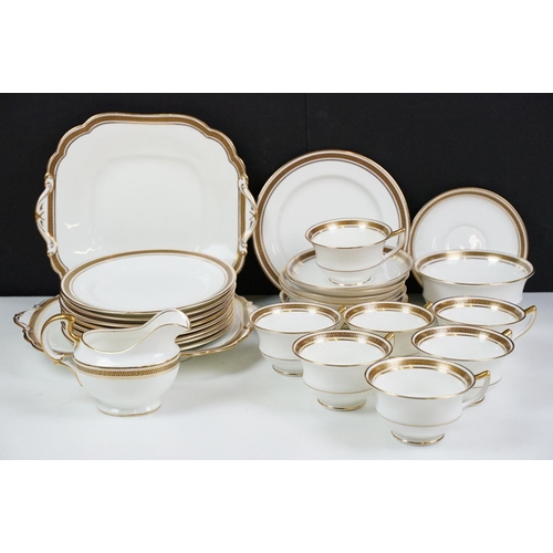 74 - Aynsley tea service having gilt rims with greek key detailing to include seven tea cups, ten saucers... 