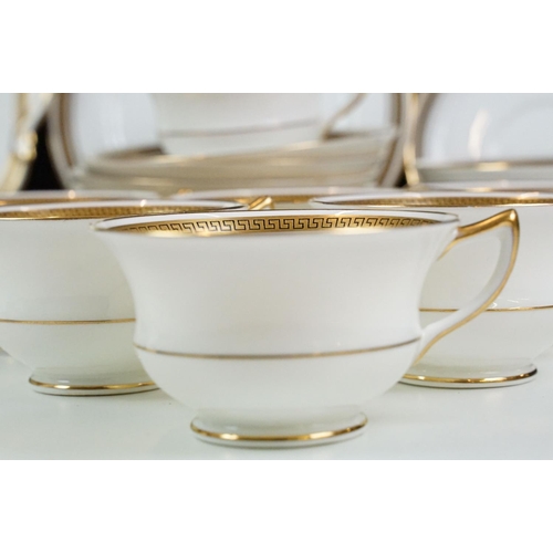 74 - Aynsley tea service having gilt rims with greek key detailing to include seven tea cups, ten saucers... 