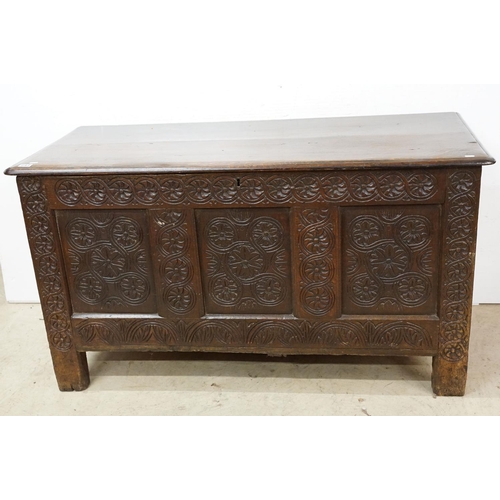 643 - Oak panelled chest, carved with stylised floral repeating designs, 79.5cm high x 142cm wide x 62cm d... 