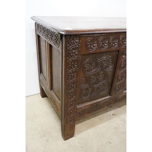 643 - Oak panelled chest, carved with stylised floral repeating designs, 79.5cm high x 142cm wide x 62cm d... 