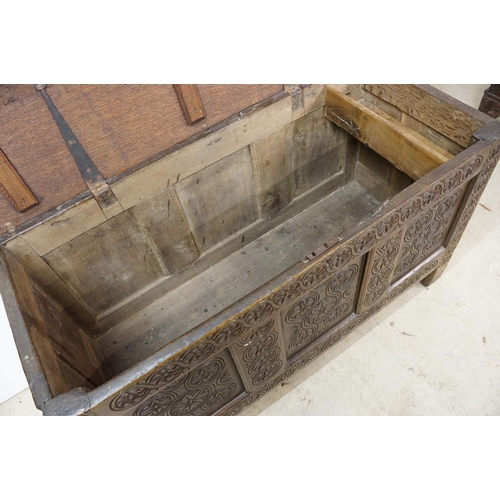 643 - Oak panelled chest, carved with stylised floral repeating designs, 79.5cm high x 142cm wide x 62cm d... 