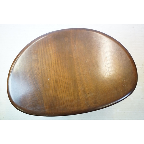 648 - Ercol nest of three dark elm pebble tables (lacking maker's labels), largest table 41cm high x 65cm ... 