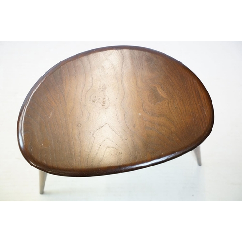 648 - Ercol nest of three dark elm pebble tables (lacking maker's labels), largest table 41cm high x 65cm ... 