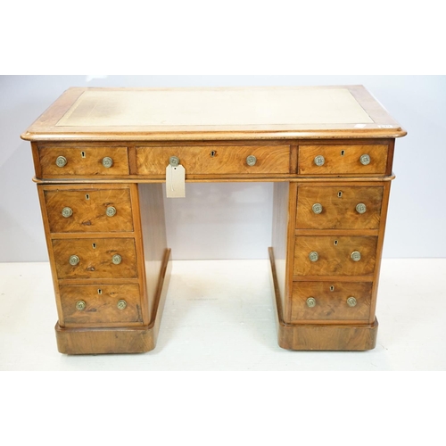 649 - Late 19th century walnut lady's kneehole desk, with cream leather inset top above an arrangement of ... 