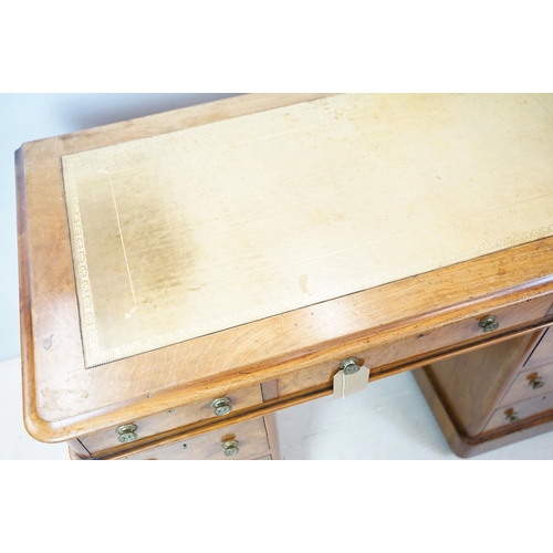 649 - Late 19th century walnut lady's kneehole desk, with cream leather inset top above an arrangement of ... 