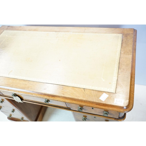 649 - Late 19th century walnut lady's kneehole desk, with cream leather inset top above an arrangement of ... 