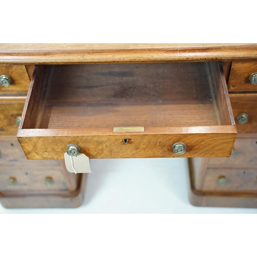 649 - Late 19th century walnut lady's kneehole desk, with cream leather inset top above an arrangement of ... 