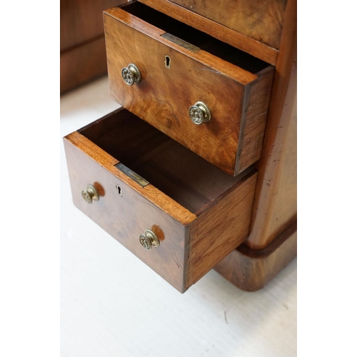 649 - Late 19th century walnut lady's kneehole desk, with cream leather inset top above an arrangement of ... 