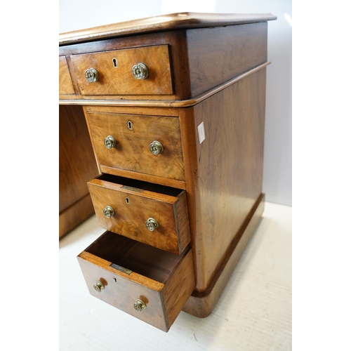 649 - Late 19th century walnut lady's kneehole desk, with cream leather inset top above an arrangement of ... 