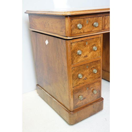 649 - Late 19th century walnut lady's kneehole desk, with cream leather inset top above an arrangement of ... 