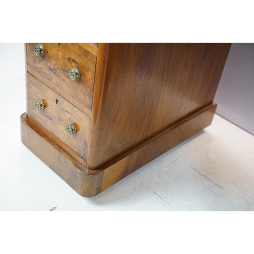 649 - Late 19th century walnut lady's kneehole desk, with cream leather inset top above an arrangement of ... 