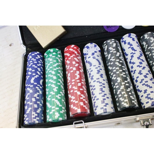 183 - Cased poker gaming set filled with coloured counters and sets of cards.