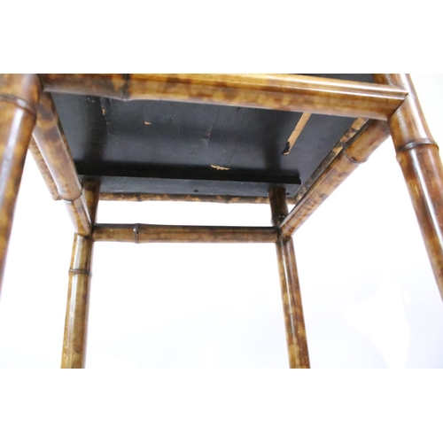 660 - Oriental bamboo work table, the black lacquered top decorated with bird and branches, with lacquer p... 