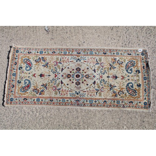 690 - Middle Eastern carpet rug having a white ground with blue florals to central panel and border. Measu... 