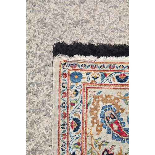 690 - Middle Eastern carpet rug having a white ground with blue florals to central panel and border. Measu... 