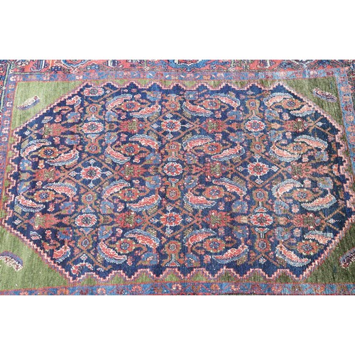 693 - Middle Eastern carpet rug having a large blue medallion to centre within a red border. Measures 183 ... 