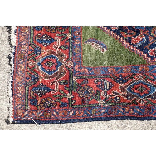 693 - Middle Eastern carpet rug having a large blue medallion to centre within a red border. Measures 183 ... 